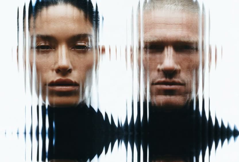 A pair of portraits dissolving into vertical streaks