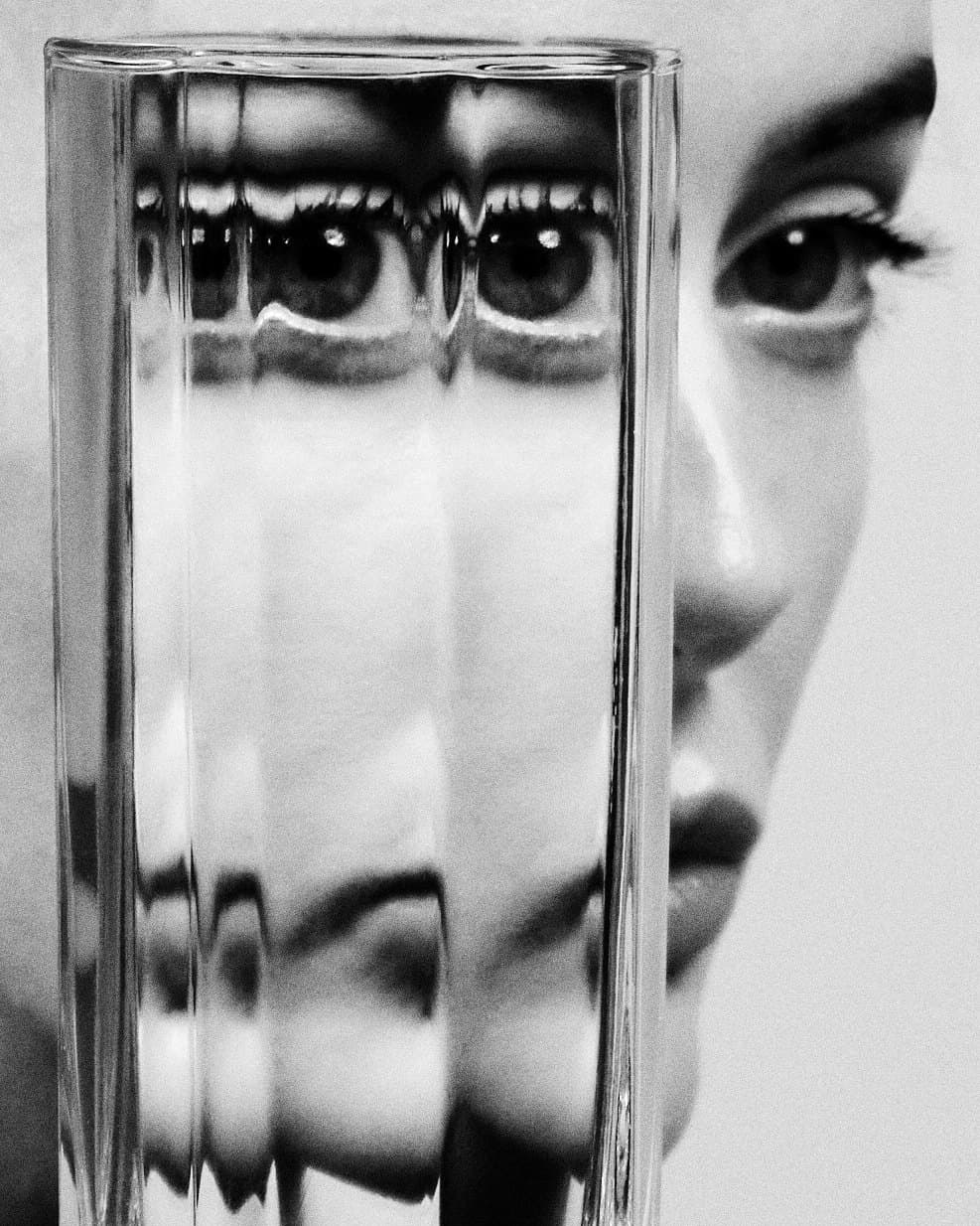 Eyes refracted through ribbed glass, in black and white