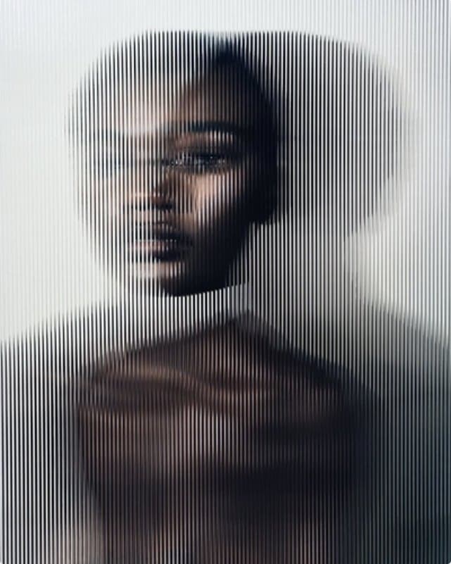 A portrait dissolved into fine vertical slices